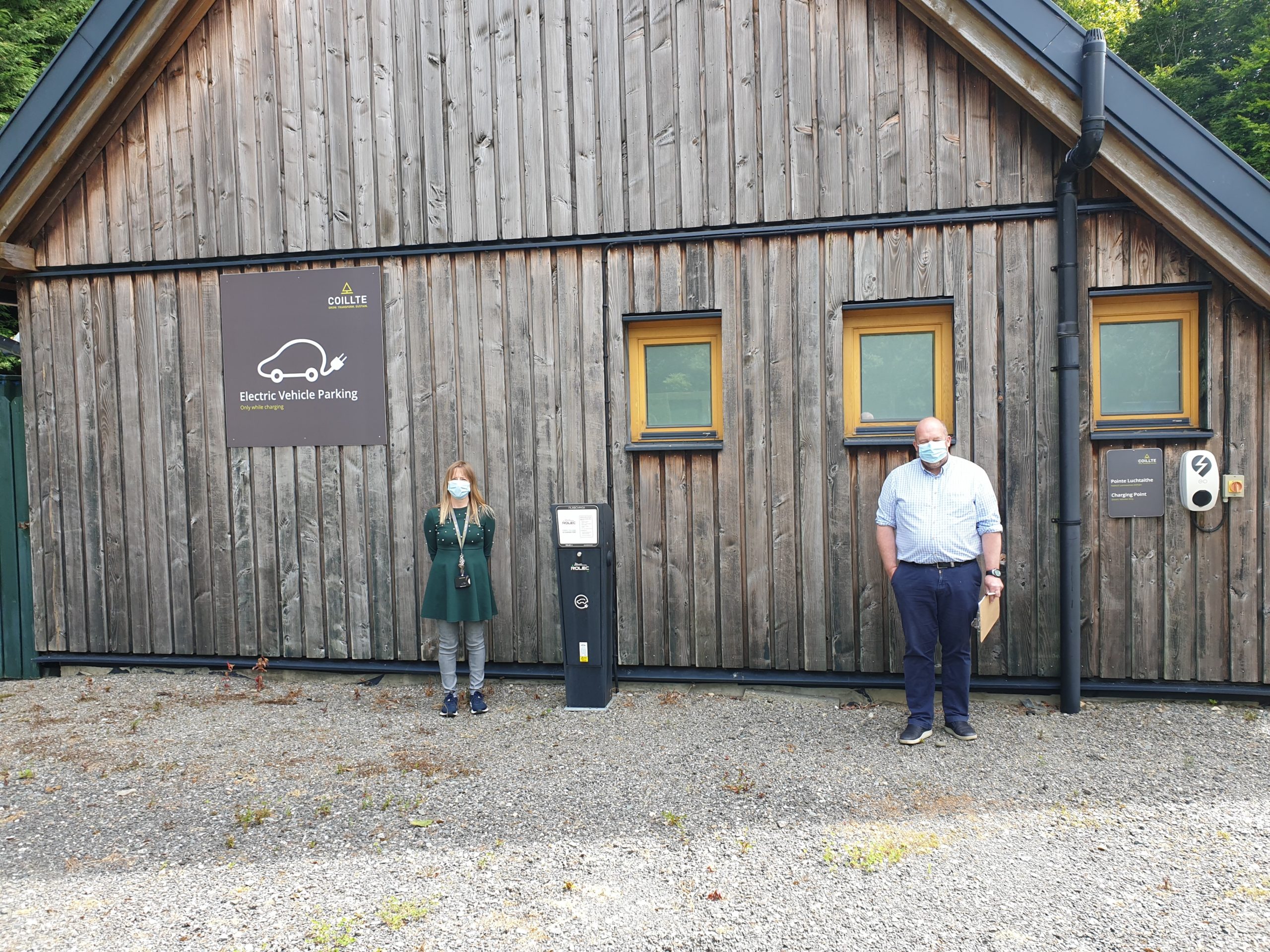 Coillte's HQ Office Manager and ISO 50001 auditor at electric car charging ports Picture of Coillte's HQ Office Manager and ISO 50001 auditor at electric car charging ports