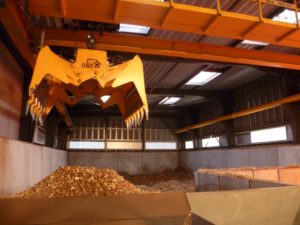 Crane lifting Coillte biomass for burning
