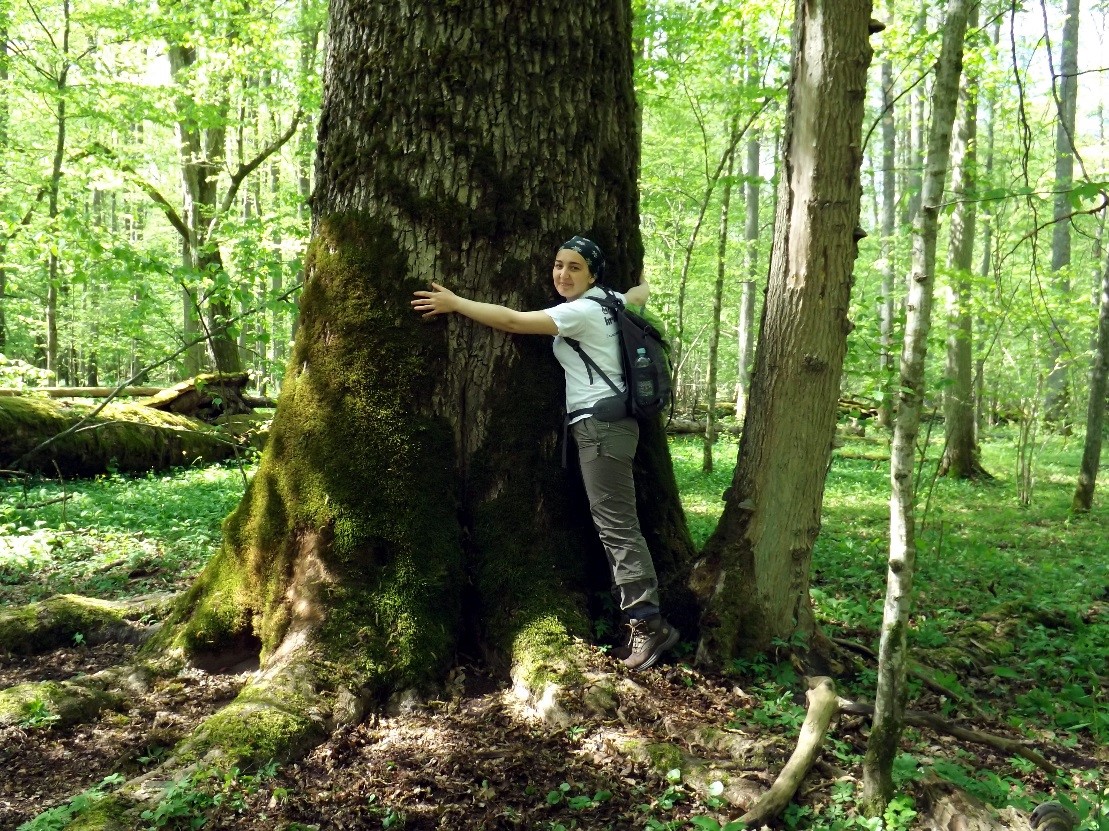 Picture of a graduate forester hugging a tree