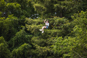 Lady descending a zipline in Coillte's farran forest park