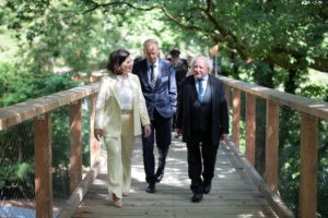 Imelda Hurley, CEO Coillte, Mark Carlin MD Coillte and Uachtarán na hÉireann Michael D Higgins walking in the sunshine along a treetop walkway